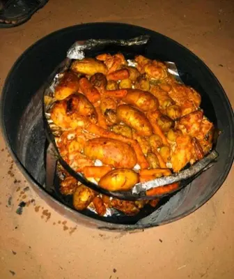 a dish of food in a pan on a table at Oasis of Civilizations Camp in Wadi Rum