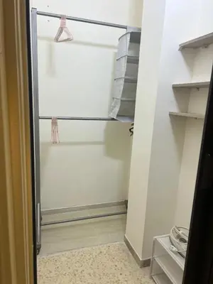 a walk in closet with a glass door at Cozy Studio Apartment in Amman