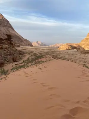 a view of a desert with mountains in the background at Stars light tent wadi rum in Wadi Rum