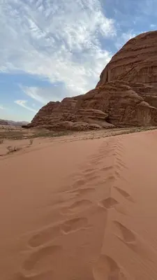 a desert with a mountain in the background at Stars light tent wadi rum in Wadi Rum