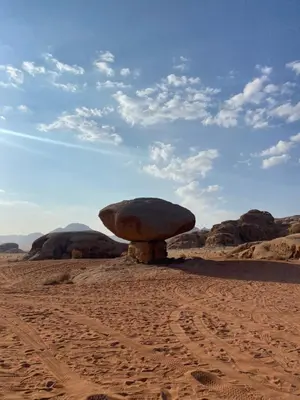 a large rock sitting in the middle of the desert at Stars light tent wadi rum in Wadi Rum