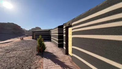 a black and white building on the side of a road at Rotana camp in Disah