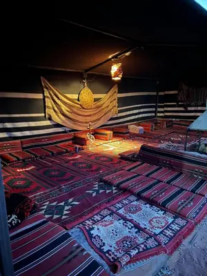 a pile of carpets on the floor in a room at Rotana camp in Disah