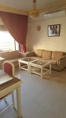 a living room with a couch and a table at Al Khaleej Hotel Apartments in Amman
