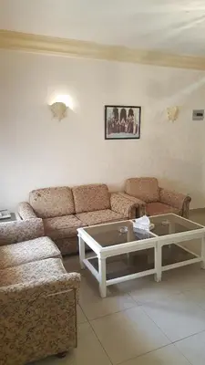 a living room with a couch and a coffee table at Al Khaleej Hotel Apartments in Amman