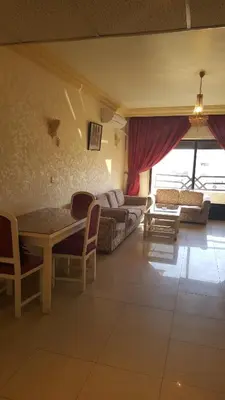 a living room with a couch and a table at Al Khaleej Hotel Apartments in Amman