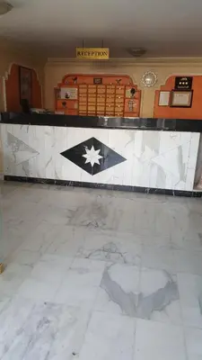 a room with a counter with a tile floor at Al Khaleej Hotel Apartments in Amman