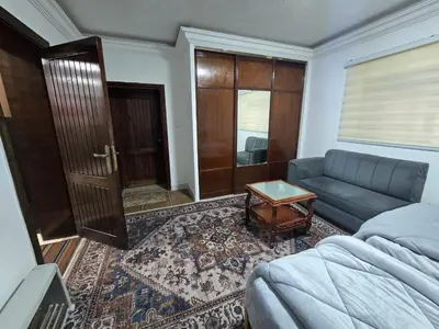 a living room with a couch and a table at Cozy Studio 2 Central Amman, Near Rainbow Street in Amman