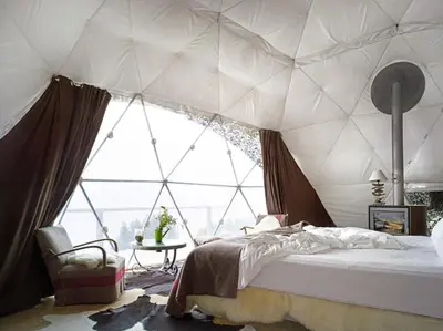 a bedroom with a tent with a large window at Magic rum luxury camp in Wadi Rum