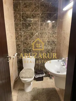 a bathroom with a toilet and a sink at Furnished apartment in Abdoun in Amman