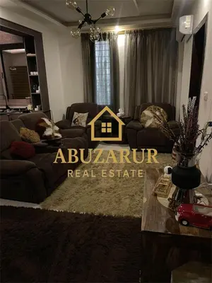 a living room with a couch and a table at Furnished apartment in Abdoun in Amman