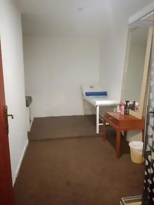 a hallway with a room with a couch and a table at Power Stay Hotel in Amman