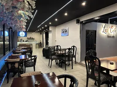 a restaurant with tables and chairs in a restaurant at Power Stay Hotel in Amman