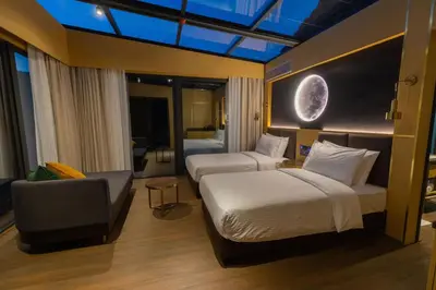 a hotel room with two beds and a couch at Rum Reserve Resort-By Luxotel in Wadi Rum