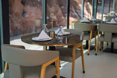 a table and chairs with napkins on top of it at Rum Reserve Resort-By Luxotel in Wadi Rum