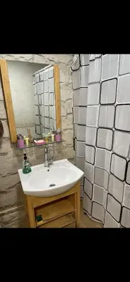a bathroom with a sink and a mirror at Rabieh Rose in Amman