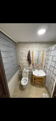 a bathroom with a toilet and a sink at Rabieh Rose in Amman