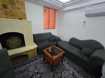 a living room with a couch and a fireplace at Studio 3 Cozy Amman Central Near Rainbow Street & First Circle in Amman