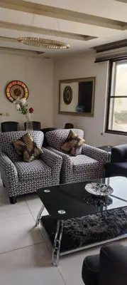 a living room with couches and a glass table at شقة مفروشة للإيجار بالرابية بالقرب من السفارة الصينية in Amman