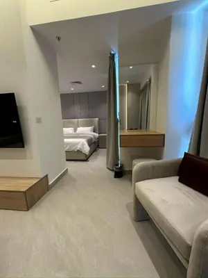a living room with a bed and a couch at Damac Amman Modern Luxury Apartment in Amman