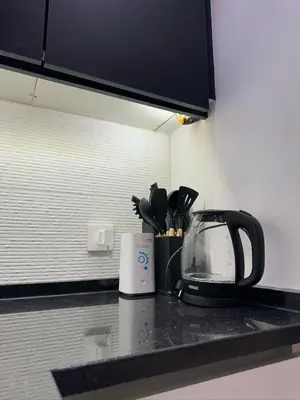 a kitchen counter with a tea kettle on a counter top at Damac Amman Modern Luxury Apartment in Amman
