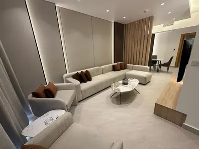 a living room with a couch and a table at Damac Amman Modern Luxury Apartment in Amman