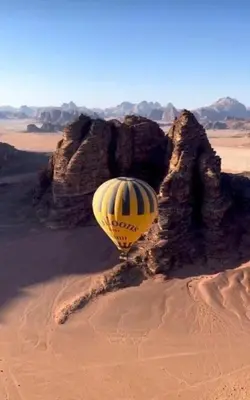 a yellow hot air balloon in the desert at Jorye Rum luxure cam in Wadi Rum