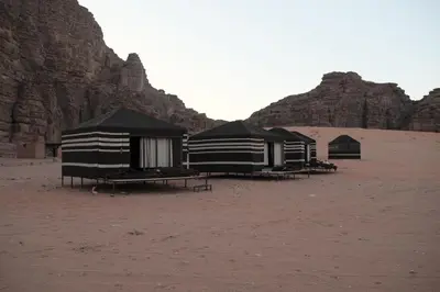 a group of tents sitting in the desert at Wadi Rum Bedouin in Wadi Rum