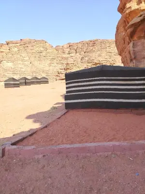a bench sitting in the middle of a desert at Nature rum camp in Wadi Rum