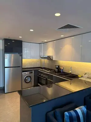 a kitchen with stainless steel appliances and a stove at DAMAC AMMAN LUXURY APARTMENTs داماك عمان شقق فاخرة in Amman