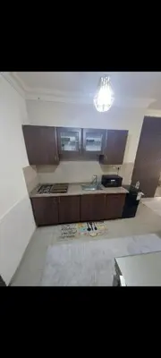 a kitchen with a sink and a counter top at Cozy Studio Gardens St Neighborhood in Amman