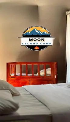 a bedroom with a bed with a sign on the wall at MOON ISLAND lUXURY CAMP in Wadi Rum