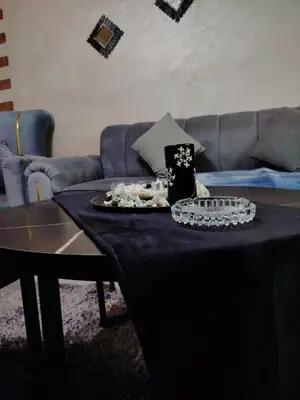 a living room with a table and a couch at طبربور in Amman