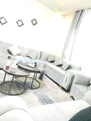 a living room with a couch and a table at طبربور in Amman