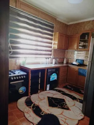 a kitchen with a sink and a stove at طبربور in Amman