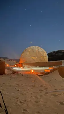 an observatory in the middle of the desert at night at Wadi Ram camp in Disah