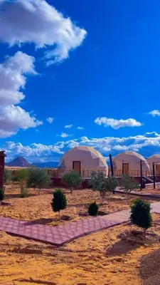 a group of domes in the middle of the desert at Amjad Rum Camp in Disah