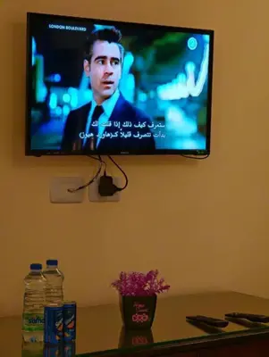 a flat screen tv hanging on a wall at I cloud Petra hostel in Wadi Musa
