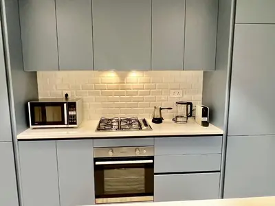 a kitchen with a stove and a microwave at Ayla in Aqaba