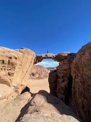 an arch in the rocks in the desert at Wadi Rum Heritage Camp in Wadi Rum