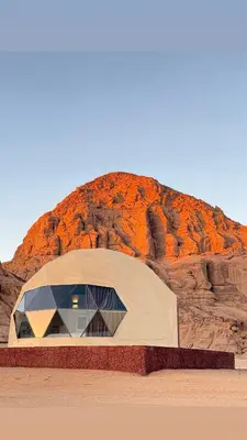 a building in front of a rock formation at Tariq Camp Wadi Rum in Wadi Rum