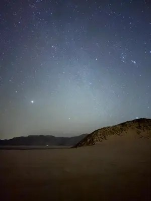 a starry night in the desert with the moon at Tariq Camp Wadi Rum in Wadi Rum