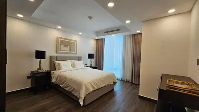 a bedroom with a large bed and a large window at Luxury 2-BR Apartment Abdali Boulevard Family in Al Jafr