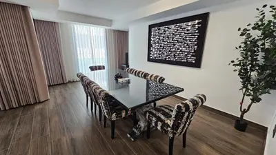 a dining room with a table and chairs at Luxury 2-BR Apartment Abdali Boulevard Family in Al Jafr