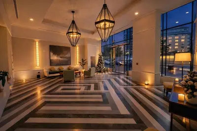 a lobby with a christmas tree in a building at Gampbell Gray Elite Abdali Apartment in Amman