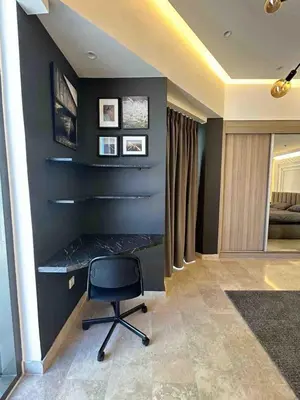a room with a desk and a chair at Luxury one bedroom apartment at Damac towers in Amman