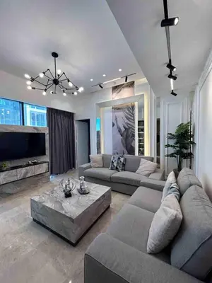 a living room with a couch and a table at Luxury one bedroom apartment at Damac towers in Amman