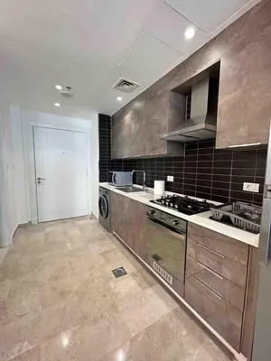 a large kitchen with a stove and a sink at Luxury one bedroom apartment at Damac towers in Amman