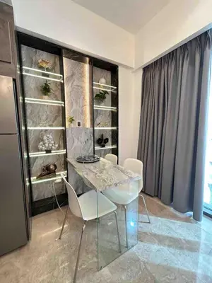 a dining room with a table and white chairs at Luxury one bedroom apartment at Damac towers in Amman