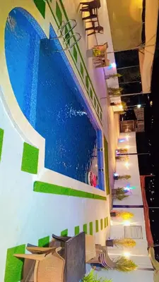 a painting of a swimming pool on the wall of a building at Green farm in Al Salt